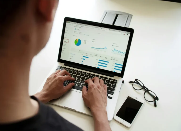 Man working on computer presumably considering vested stock.