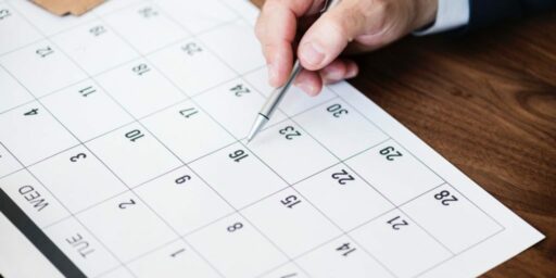 hand pointing to January 31 deadline on calendar with pen