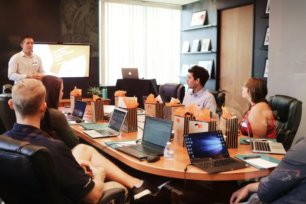 Employees at a meeting discussing the foreign subsidiary playbook.