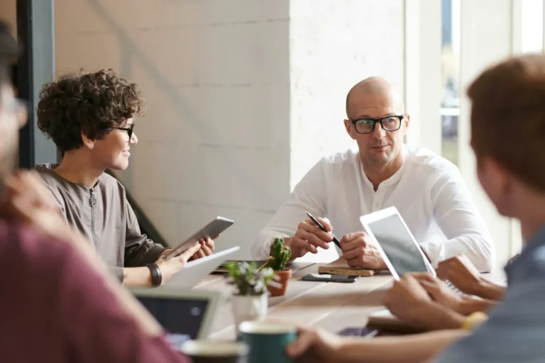 A group of people sitting around a table.