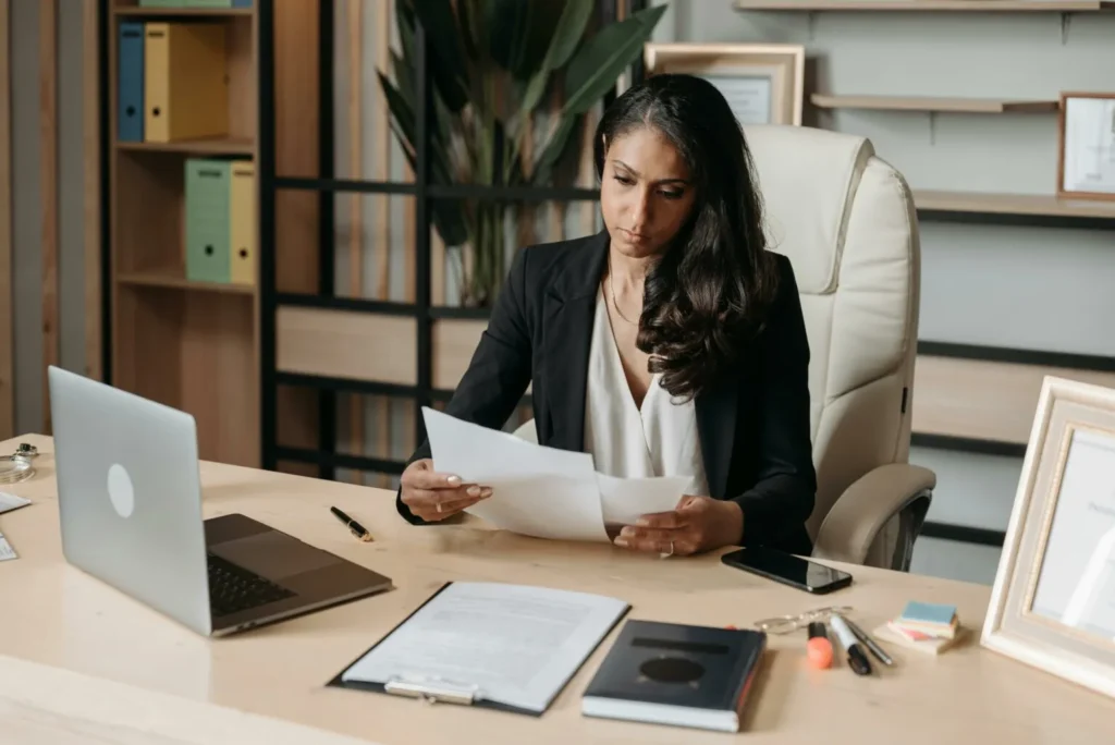 Person sitting and desk and looking at Form 5471 Schedule I-1