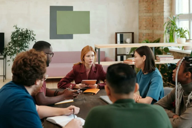 A team discussing Form 1042-S around a table.